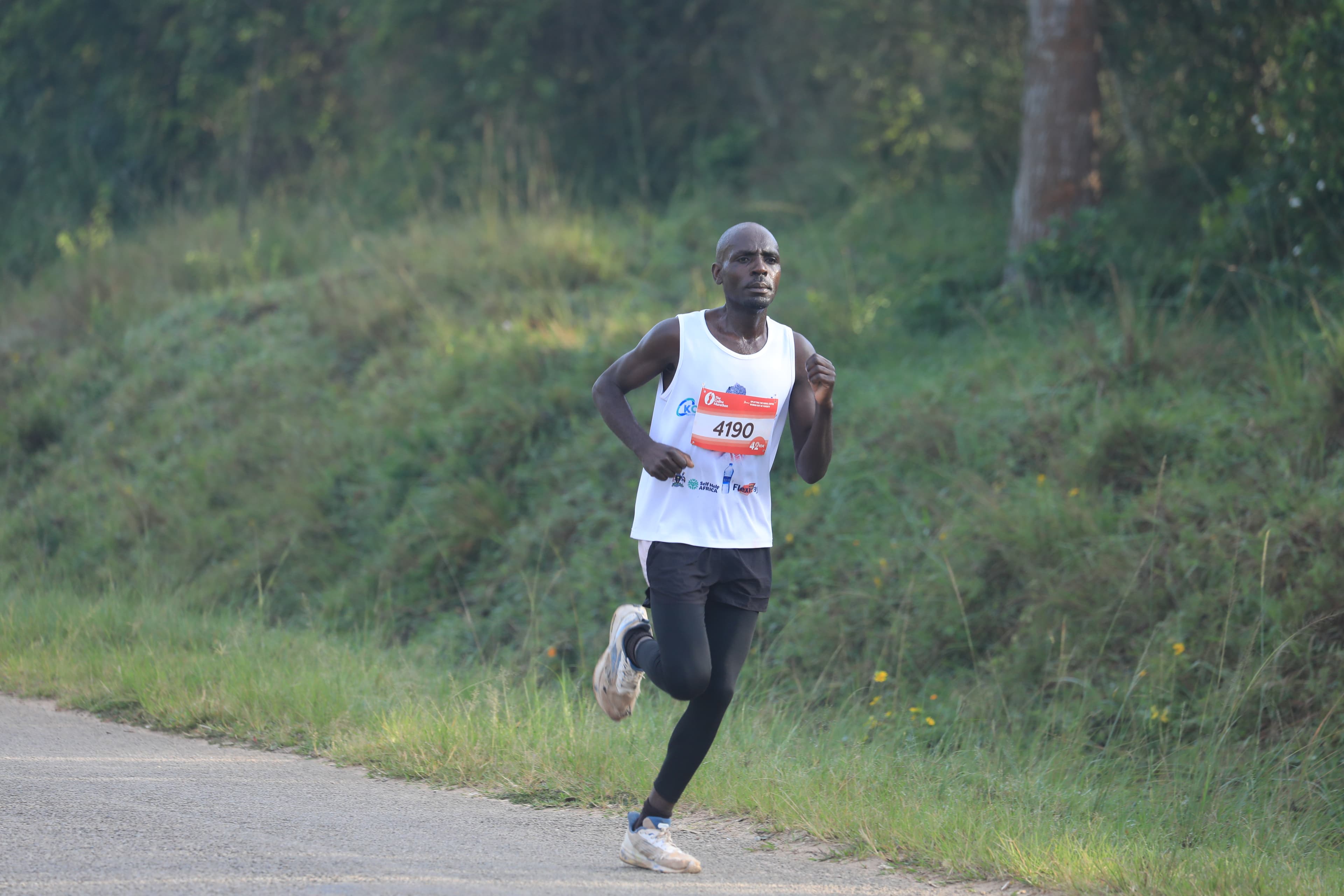 Elite runner on the highland route — Coffee Marathon 2025
